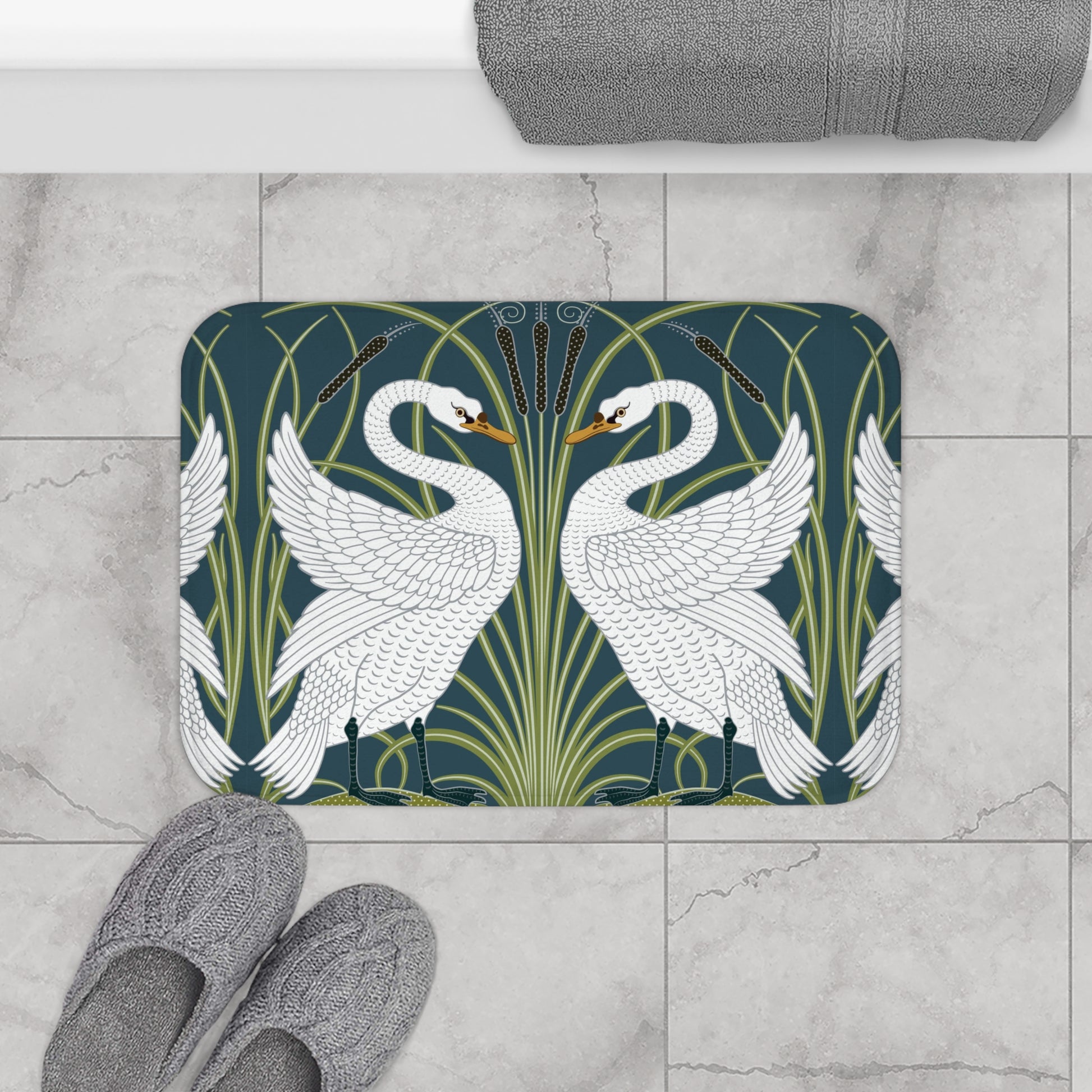 Decorative bath mat with swan design on a tiled floor