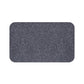 A rectangular microfibre bath mat with an all-over print of acorns and oak leaves in a smoky blue colour.