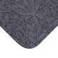 A rectangular microfibre bath mat with an all-over print of acorns and oak leaves in a smoky blue colour.