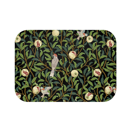 Microfibre bath mat with a design inspired by William Morris featuring birds and pomegranates on a dark background.