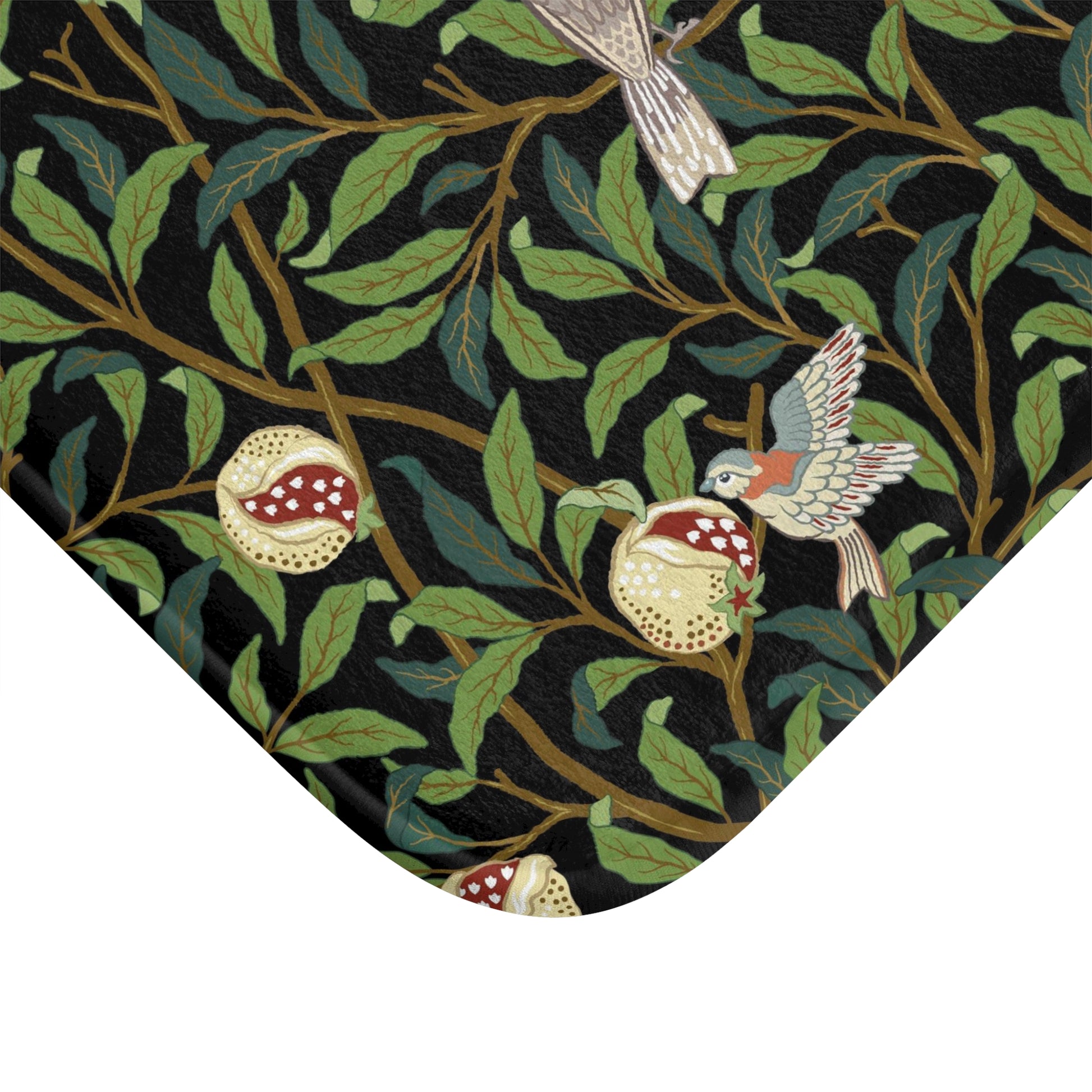 Microfibre bath mat with a design inspired by William Morris featuring birds and pomegranates on a dark background.