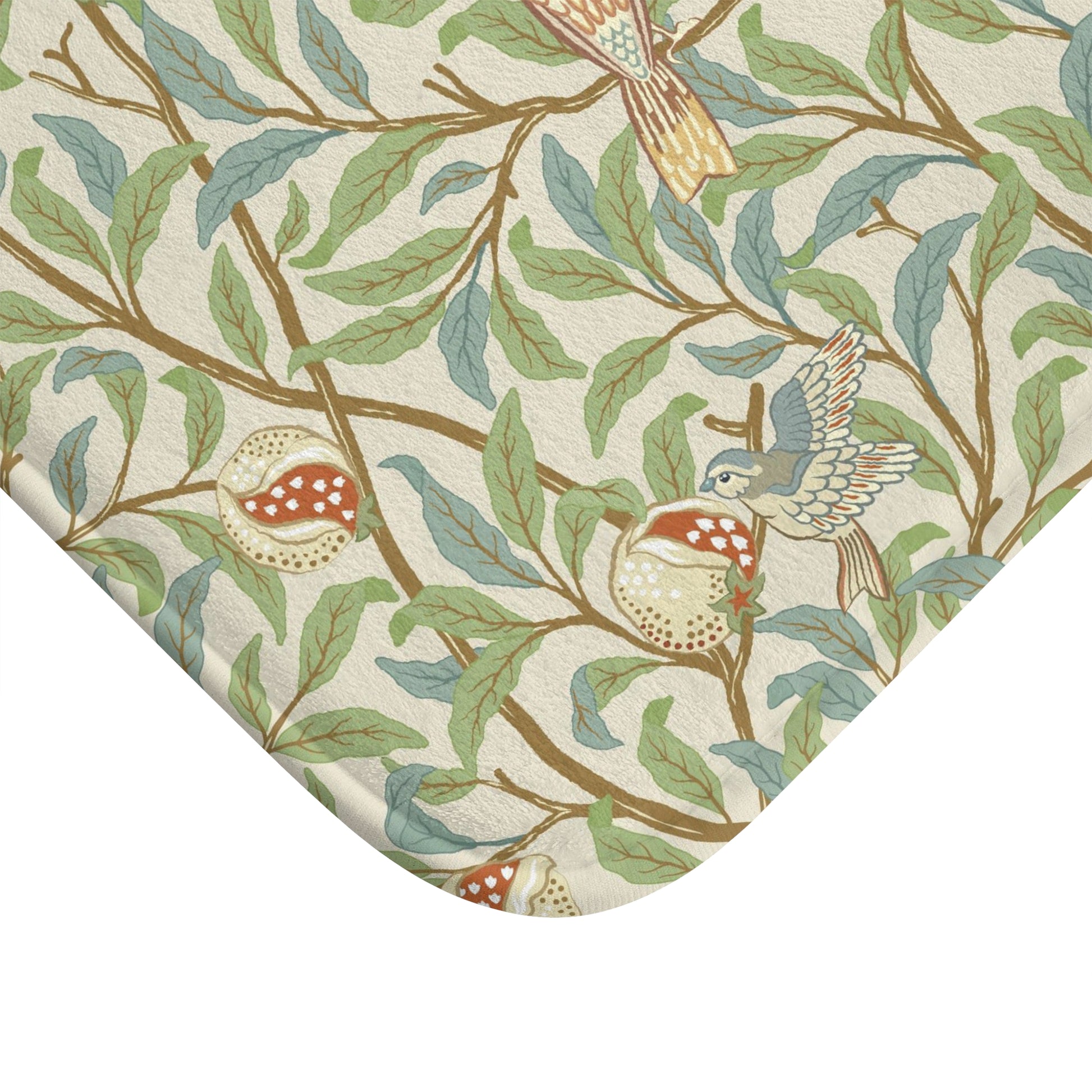 Microfibre bath mat with a floral pattern featuring birds and pomegranates in a beige colour inspired by William Morris.