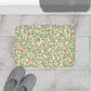 Microfibre bath mat with a floral pattern featuring birds and pomegranates in a beige colour inspired by William Morris.
