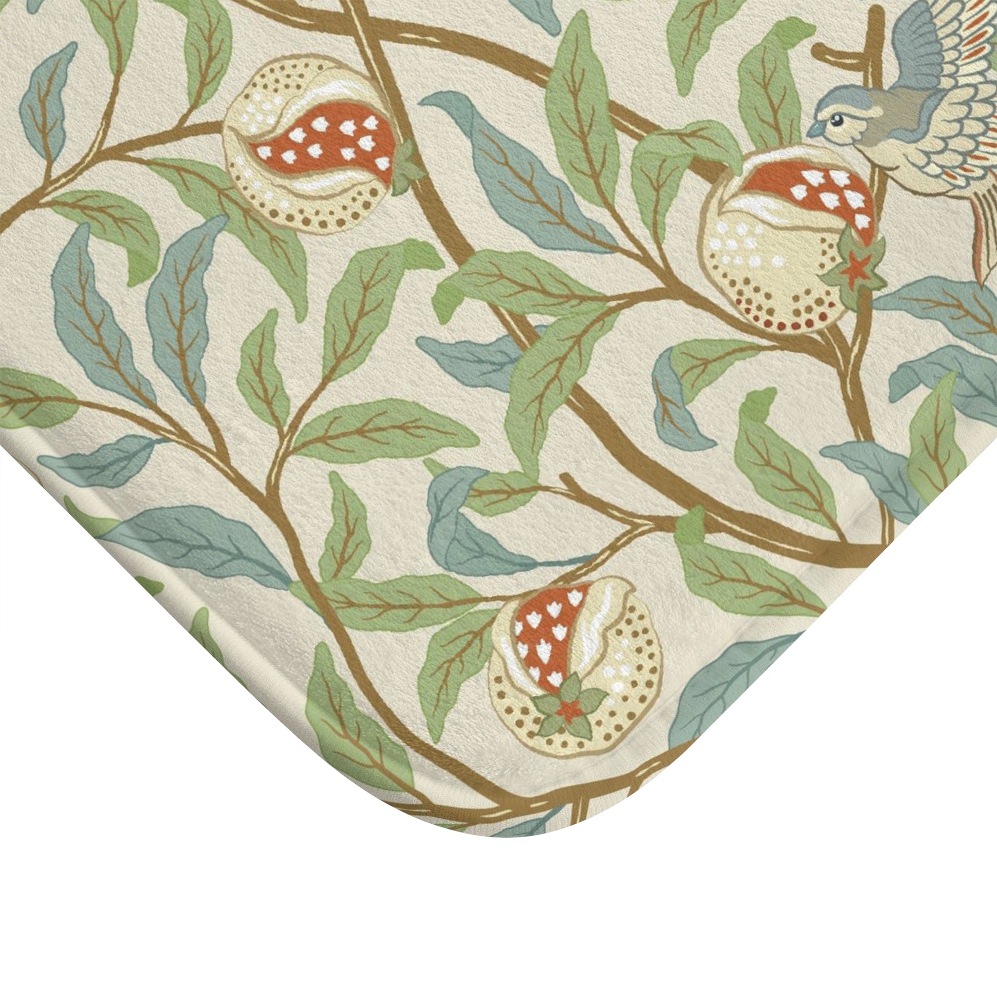 Microfibre bath mat with a floral pattern featuring birds and pomegranates in a beige colour inspired by William Morris.