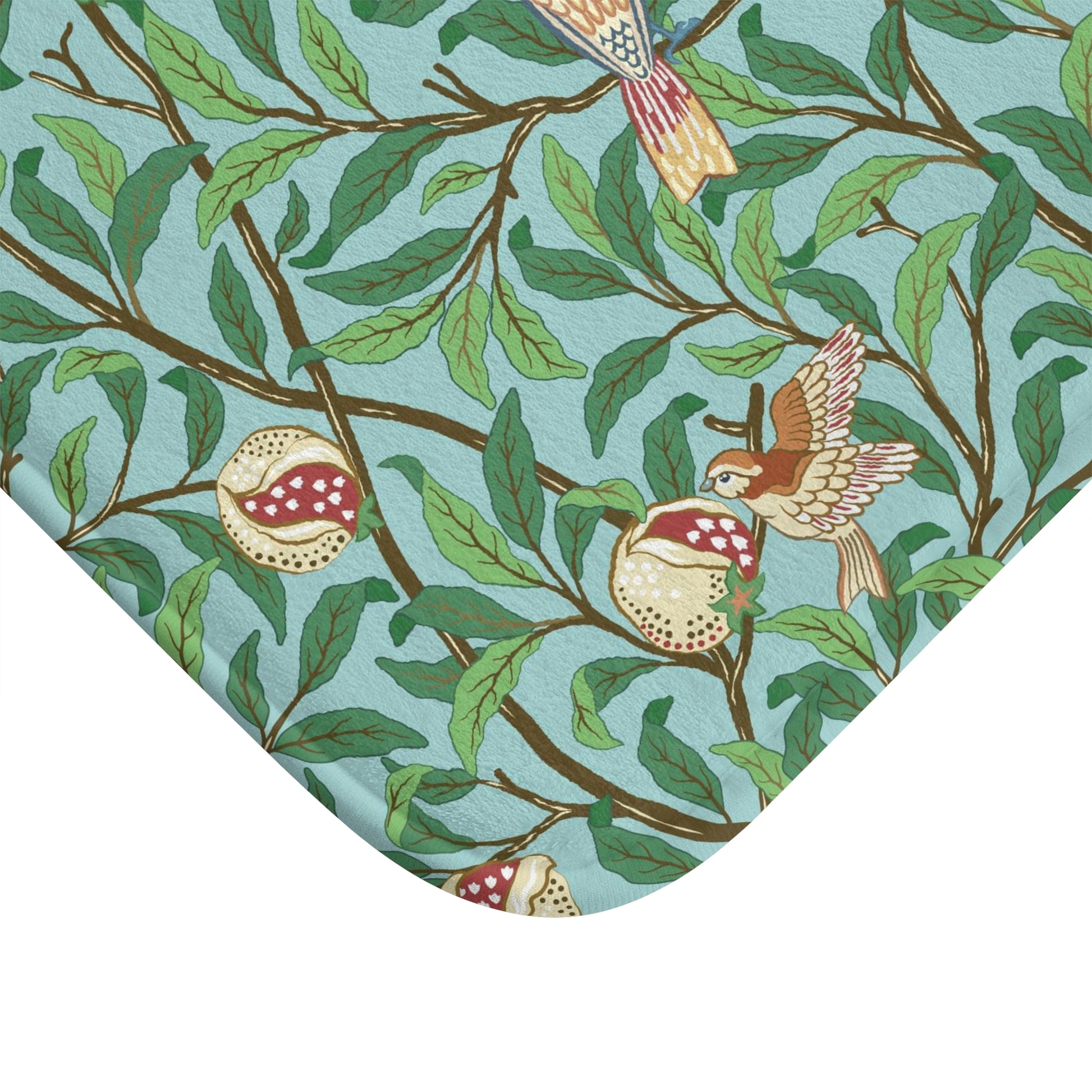 A rectangular microfibre bath mat with a Tiffany Blue background featuring an elegant William Morris bird and pomegranate pattern.