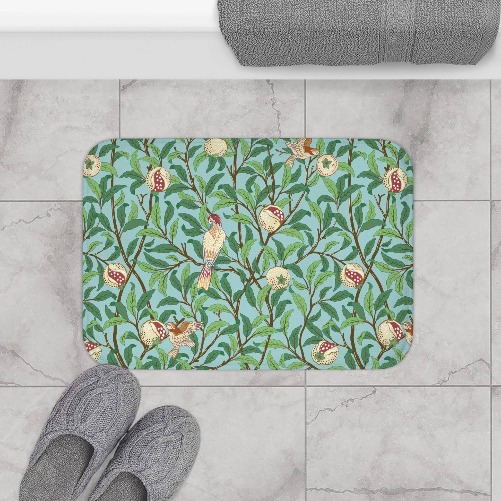 A rectangular microfibre bath mat with a Tiffany Blue background featuring an elegant William Morris bird and pomegranate pattern.