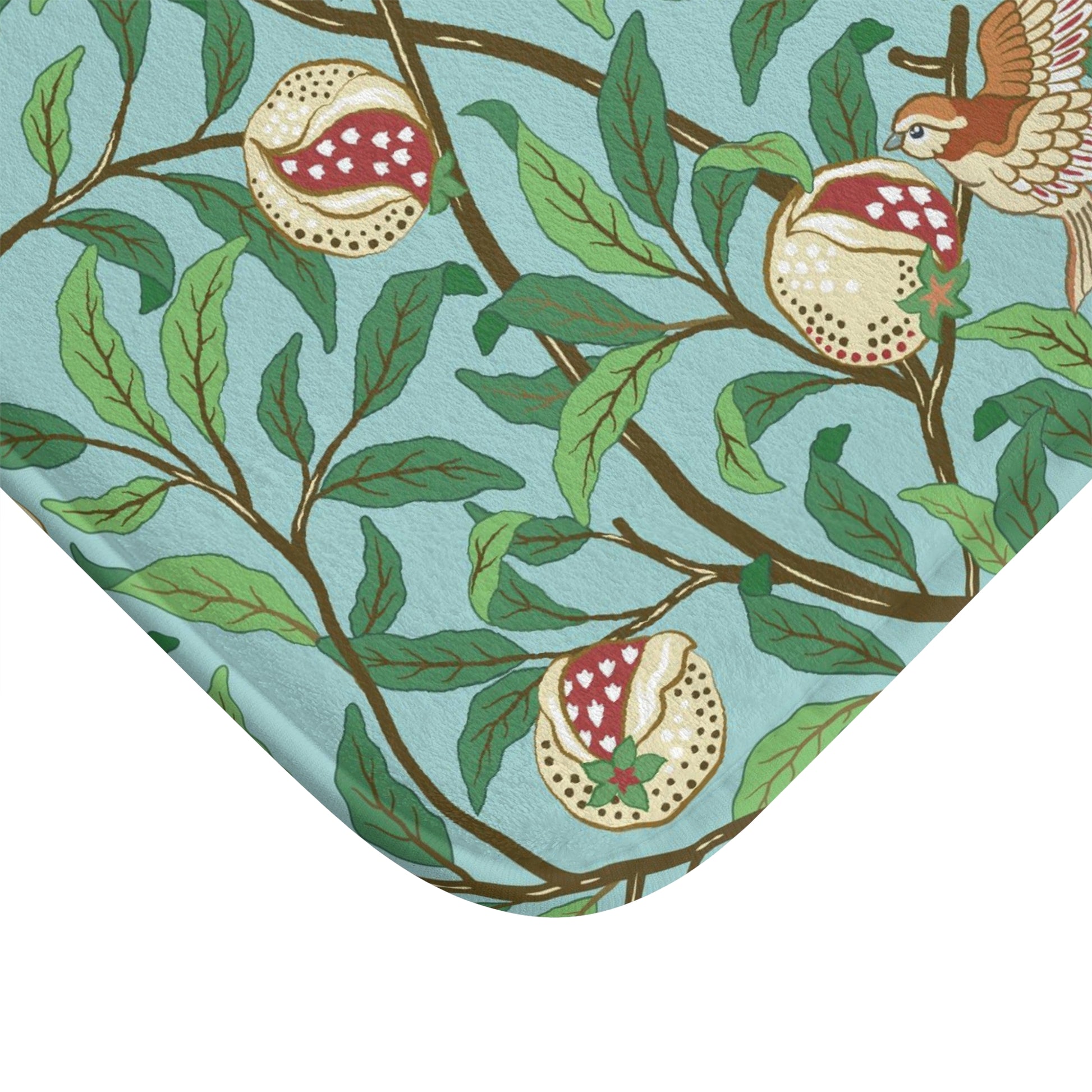 A rectangular microfibre bath mat with a Tiffany Blue background featuring an elegant William Morris bird and pomegranate pattern.
