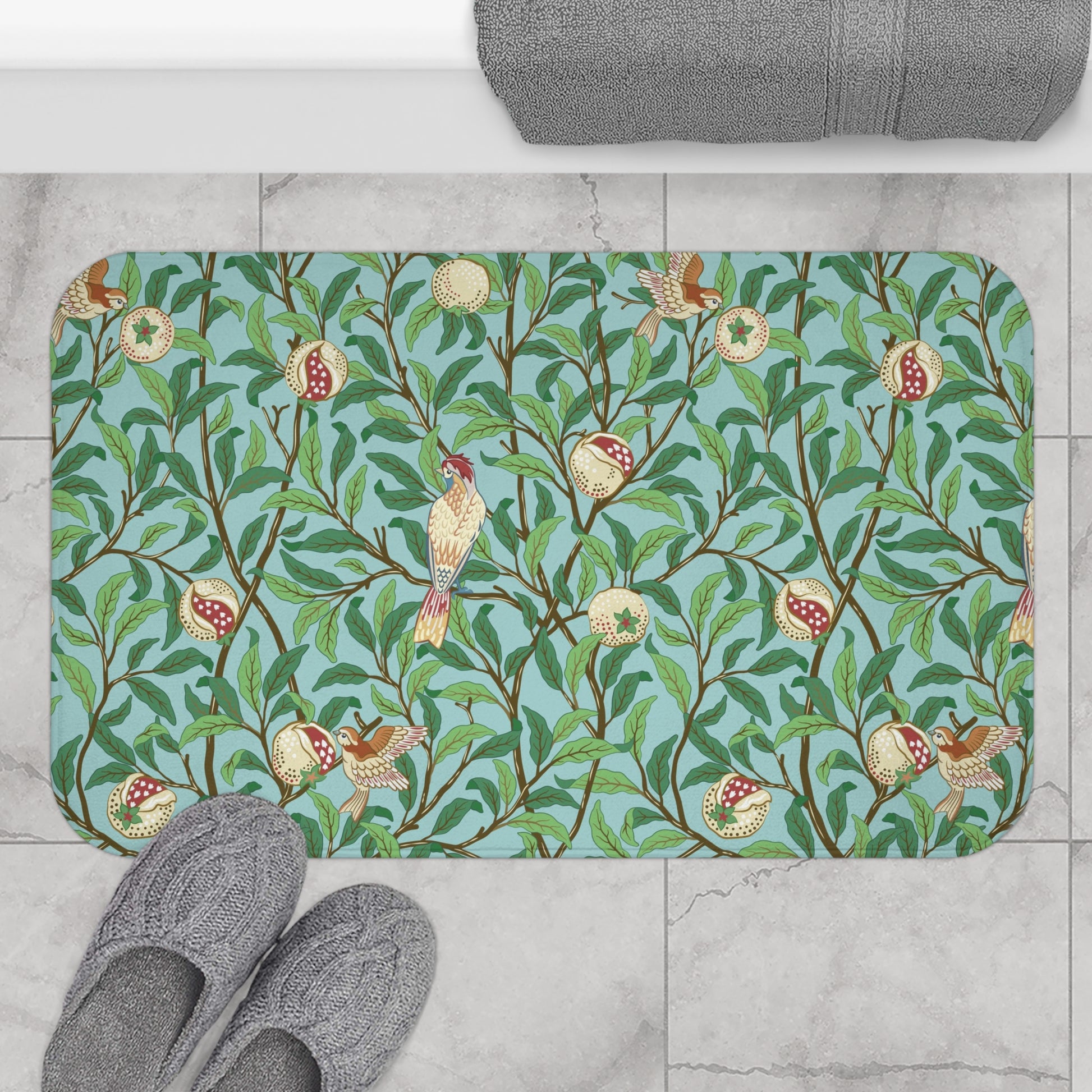 A rectangular microfibre bath mat with a Tiffany Blue background featuring an elegant William Morris bird and pomegranate pattern.