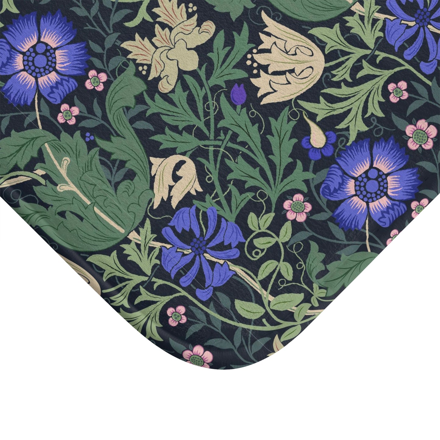 A rectangular microfibre bath mat with a floral pattern inspired by William Morris, predominantly blue and green in colour.