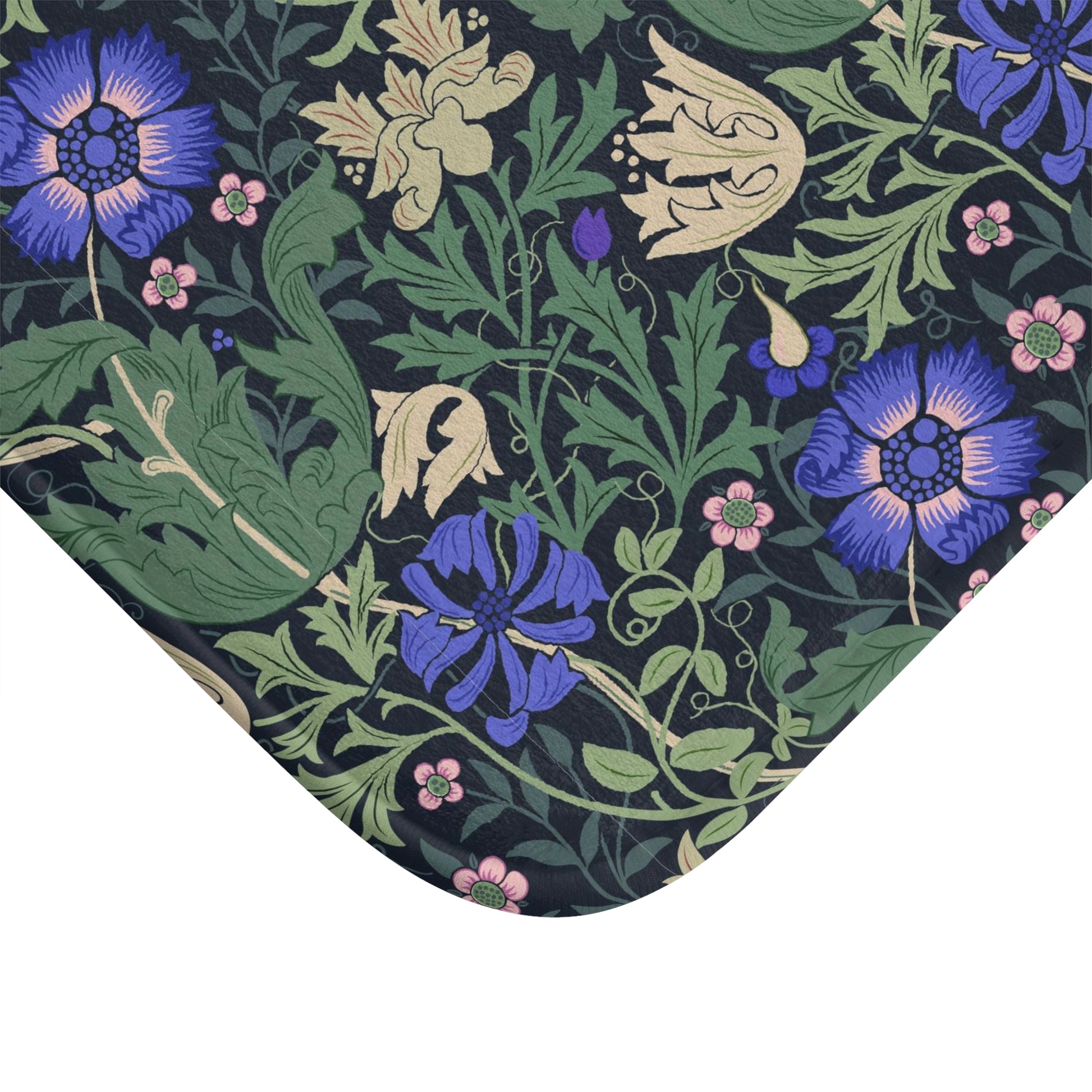 A rectangular microfibre bath mat with a floral pattern inspired by William Morris, predominantly blue and green in colour.