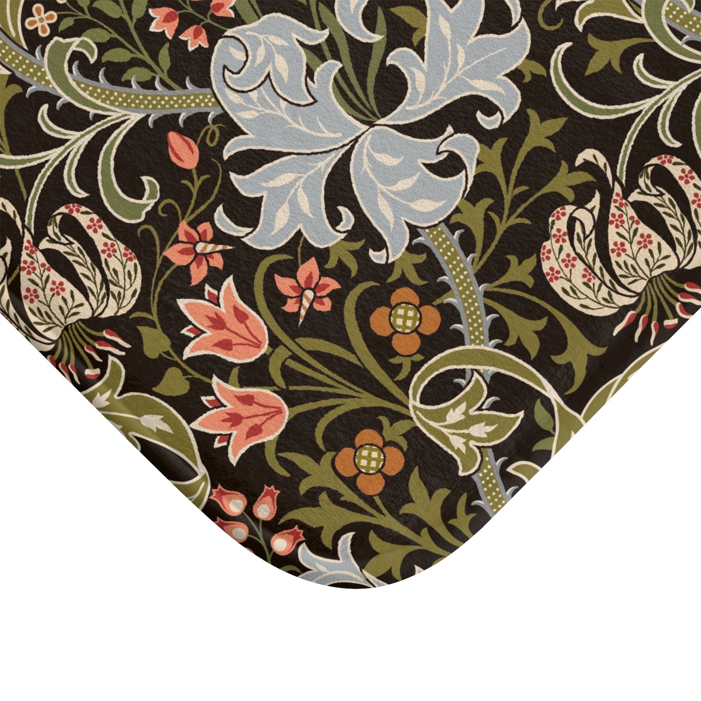 A rectangular microfibre bath mat with a floral pattern inspired by William Morris, predominantly in dark colours with a mix of lilies and other foliage.