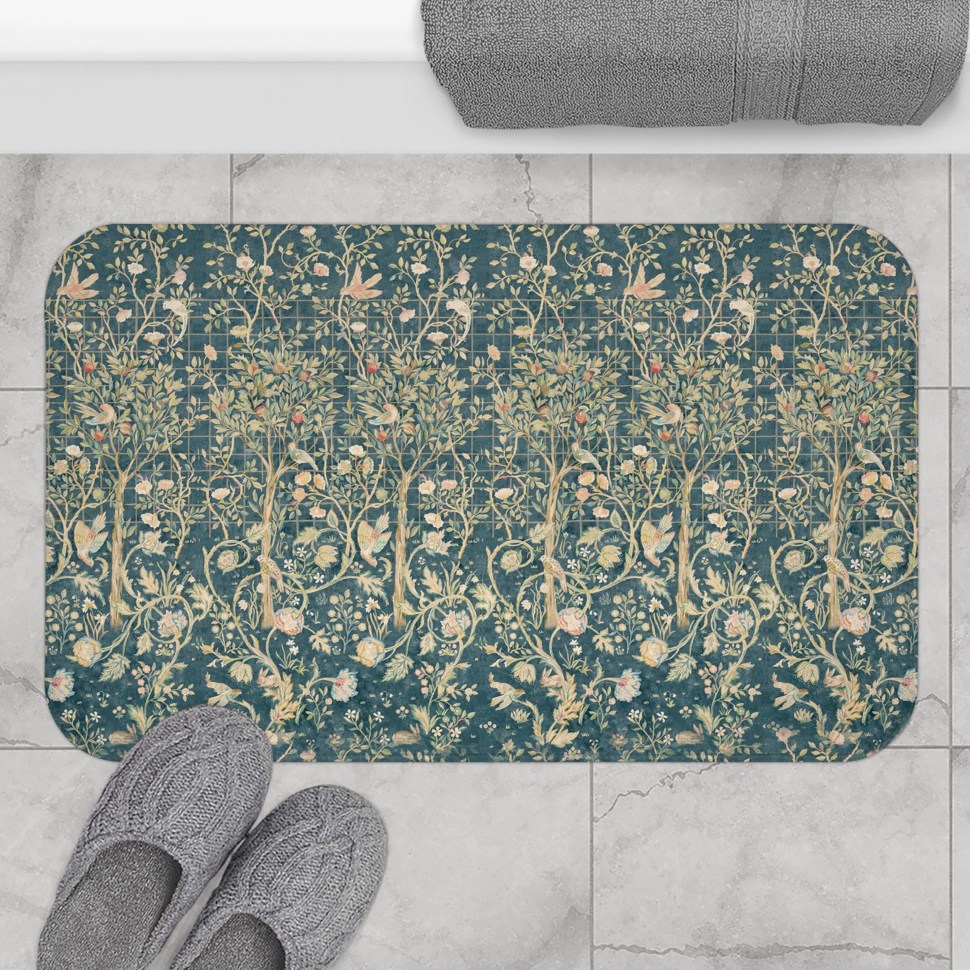 Floral patterned bath mat on a tiled floor with slippers nearby