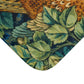 A microfibre bath mat with a William Morris  floral pattern featuring an artistic representation of a pheasant surrounded by leaves.