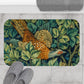 A microfibre bath mat with a William Morris  floral pattern featuring an artistic representation of a pheasant surrounded by leaves.