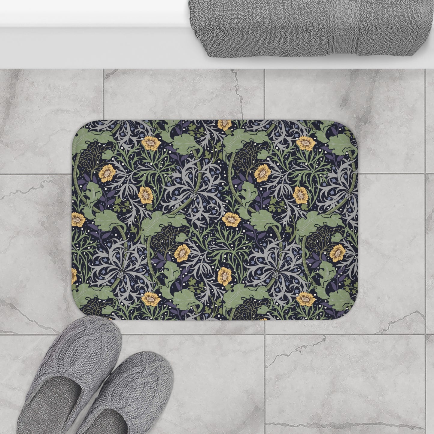 Microfibre bath mat with a floral pattern inspired by William Morris, predominantly yellow flowers with green leaves on a black background.