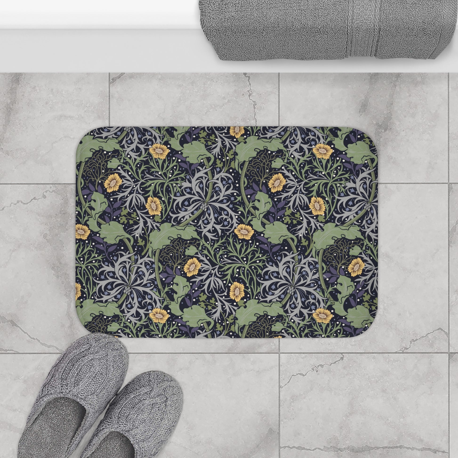 Microfibre bath mat with a floral pattern inspired by William Morris, predominantly yellow flowers with green leaves on a black background.