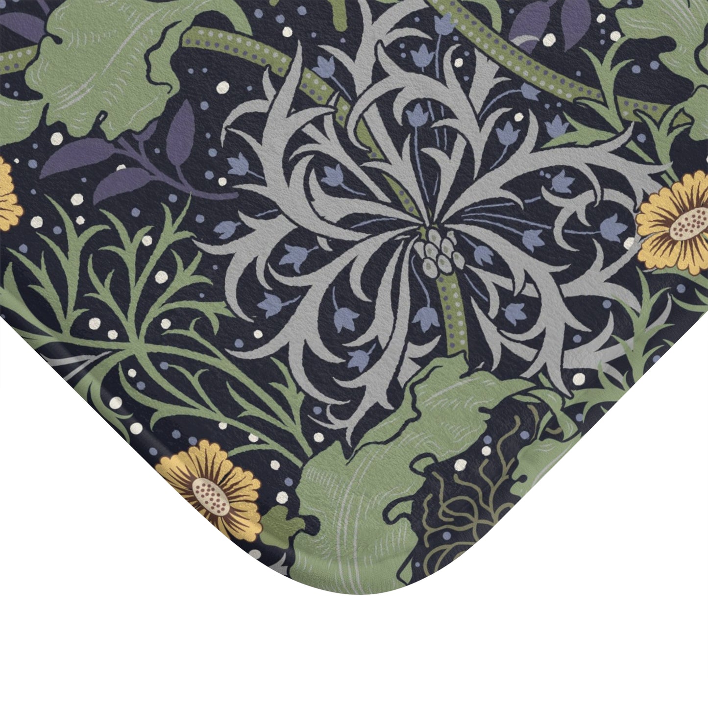 Microfibre bath mat with a floral pattern inspired by William Morris, predominantly yellow flowers with green leaves on a black background.
