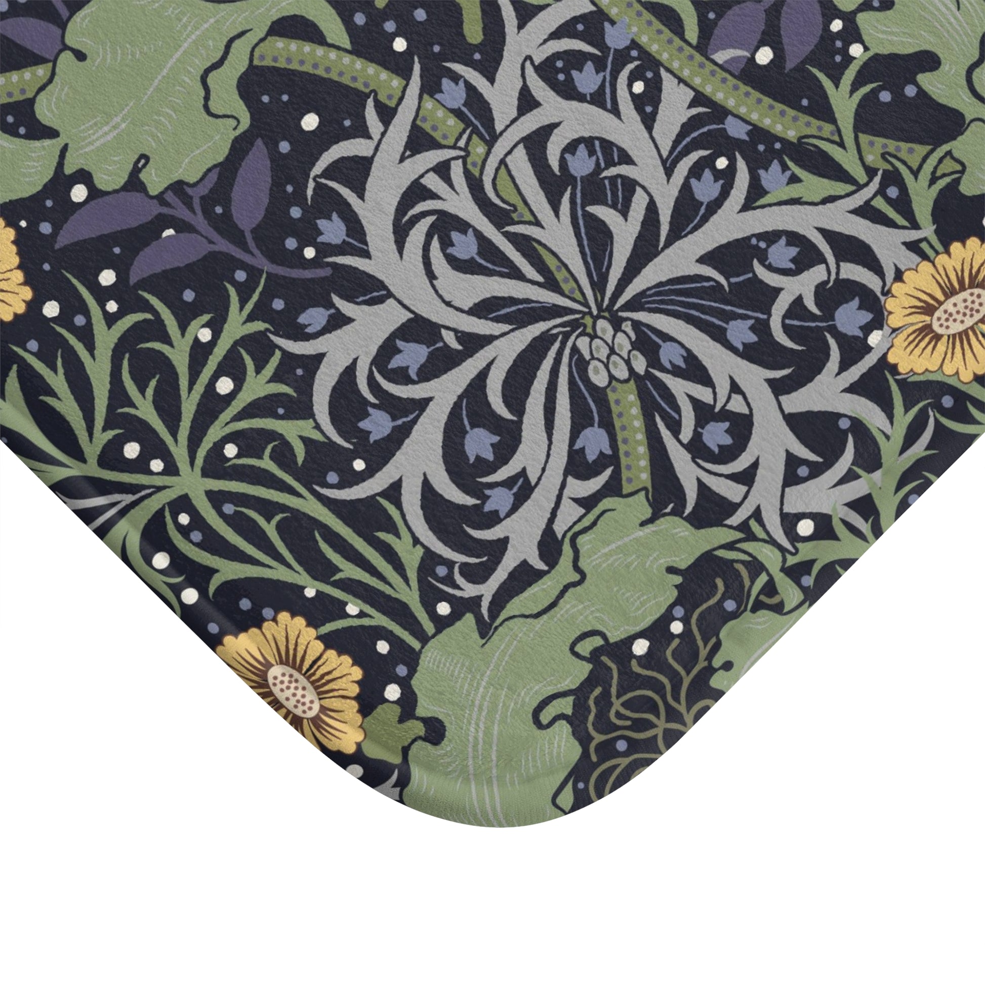 Microfibre bath mat with a floral pattern inspired by William Morris, predominantly yellow flowers with green leaves on a black background.