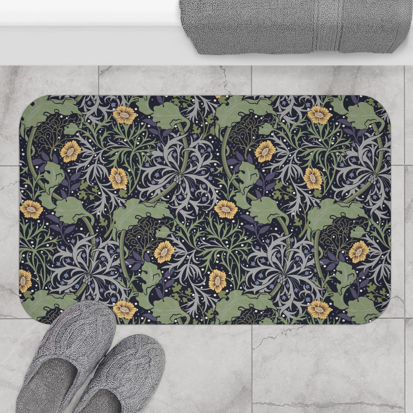 Microfibre bath mat with a floral pattern inspired by William Morris, predominantly yellow flowers with green leaves on a black background.