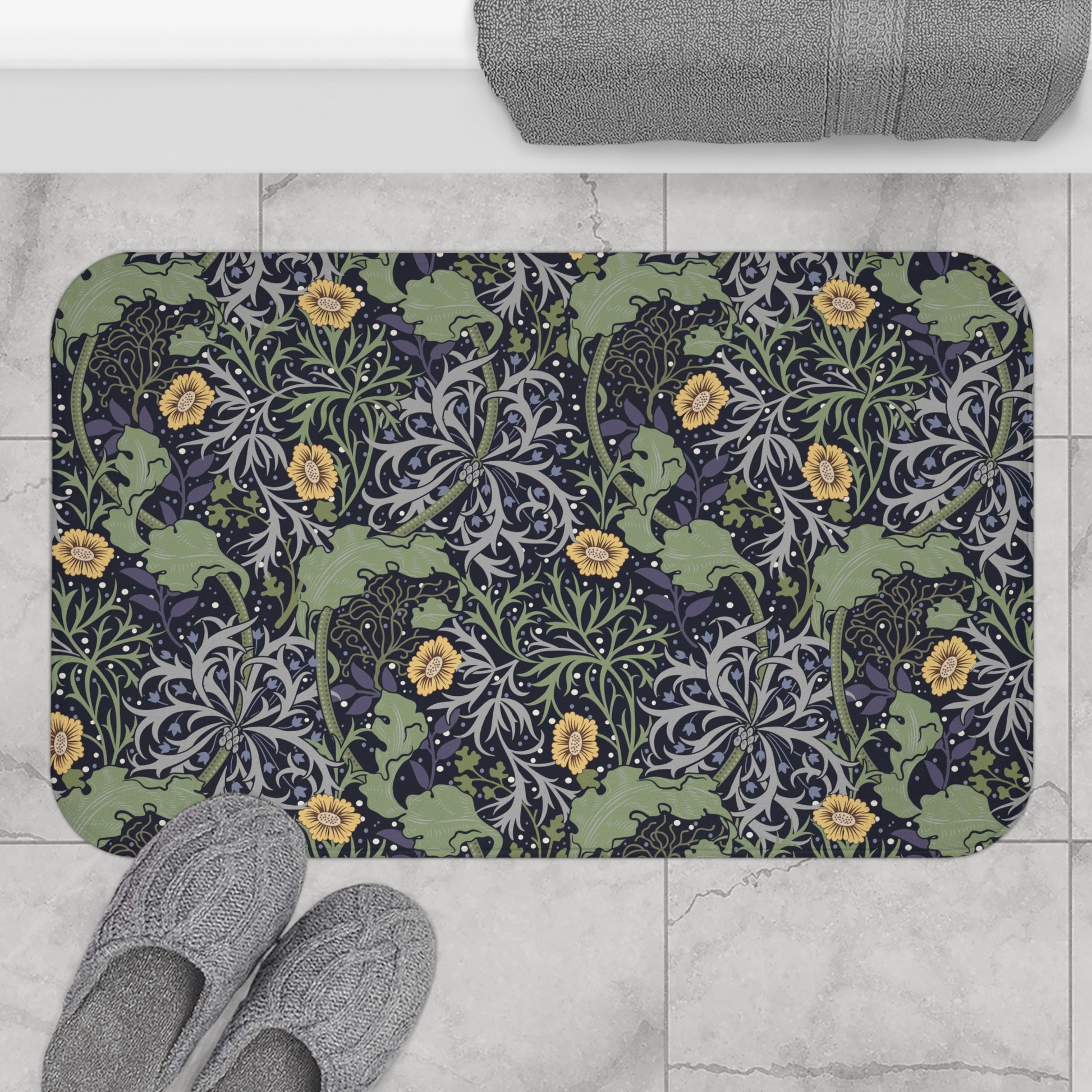 Microfibre bath mat with a floral pattern inspired by William Morris, predominantly yellow flowers with green leaves on a black background.