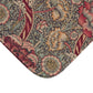 A rectangular microfibre bath mat with a floral pattern inspired by William Morris, predominantly red with a non-slip black border.