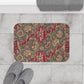 A rectangular microfibre bath mat with a floral pattern inspired by William Morris, predominantly red with a non-slip black border.