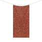 A rectangular textile hanging from a clothesline with two wooden clips, featuring an all-over botanical pattern in warm rust and terracotta tones on a white background.