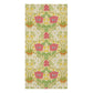 A vertical rectangular bath towel featuring an ornate floral pattern with pink flowers, green leaves, yellow accents, and small white blossoms on a warm cream background.