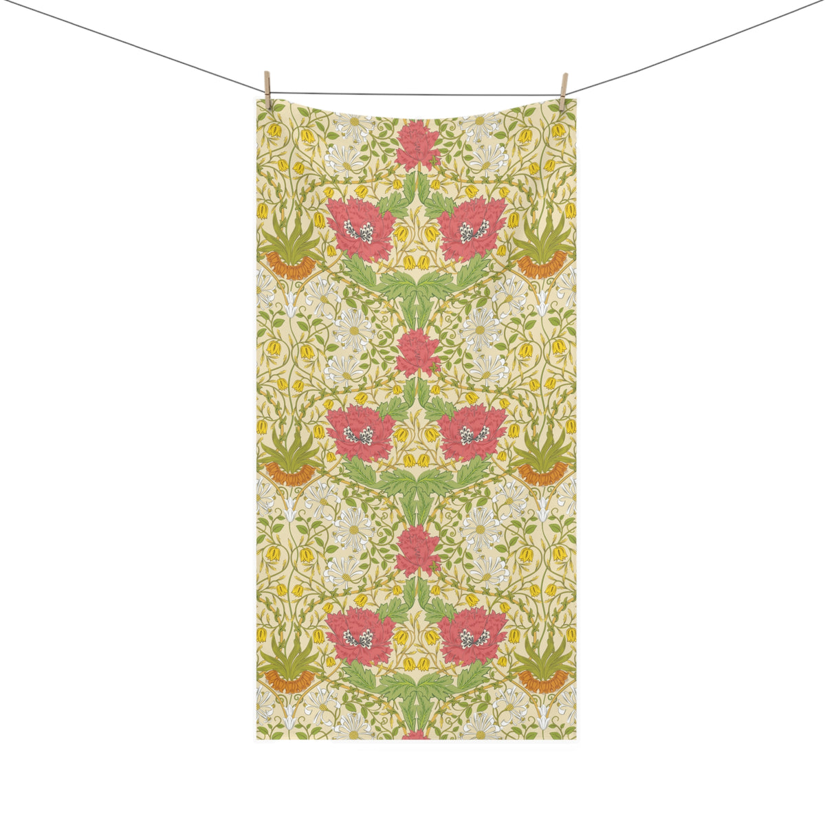 A rectangular bath towel with a symmetrical floral pattern, hanging from two wooden clothespins on a thin horizontal line against a solid white background.