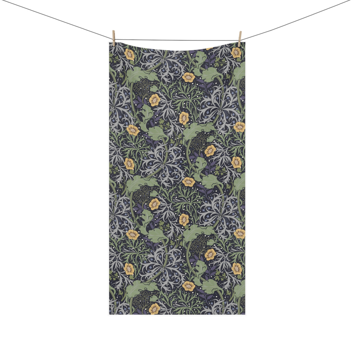 A rectangular fabric towel with a dense botanical pattern, hanging from a clothesline with two wooden clips against a plain white background.