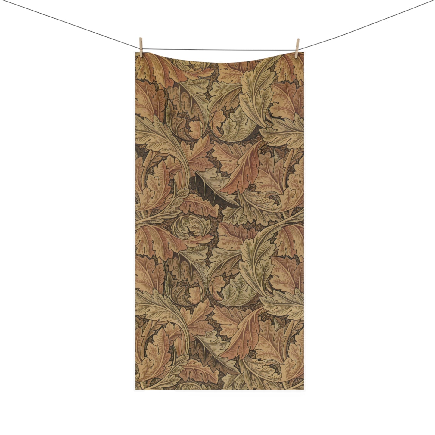 A rectangular fabric towel or blanket with a vintage-style botanical leaf pattern in warm brown, tan, and olive tones, hanging from two wooden clips on a clothesline against a plain white background.