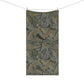 A rectangular fabric towel or blanket with an intricate vintage-style botanical pattern of oak leaves, hanging from a clothesline with two wooden clips against a solid white background.