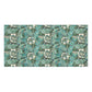 A rectangular bath towel with a dense botanical pattern featuring teal, green, and white flowers and leaves on a dark background, shown flat against a white backdrop.