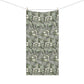 A rectangular fabric towel with a dense botanical pattern of white flowers and green leaves on a dark gray background, hanging from two wooden clothespins on a thin wire against a plain white background.