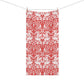 A rectangular fabric towel with a red and white ornate damask pattern, hanging from two wooden clothespins on a thin horizontal line against a plain white background.