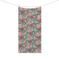 A rectangular fabric towel with a vintage floral pattern, hanging from two wooden clothespins on a string against a plain white background.