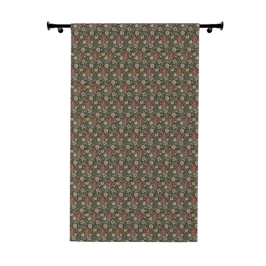 Floral patterned curtain hanging on a rod against a white background