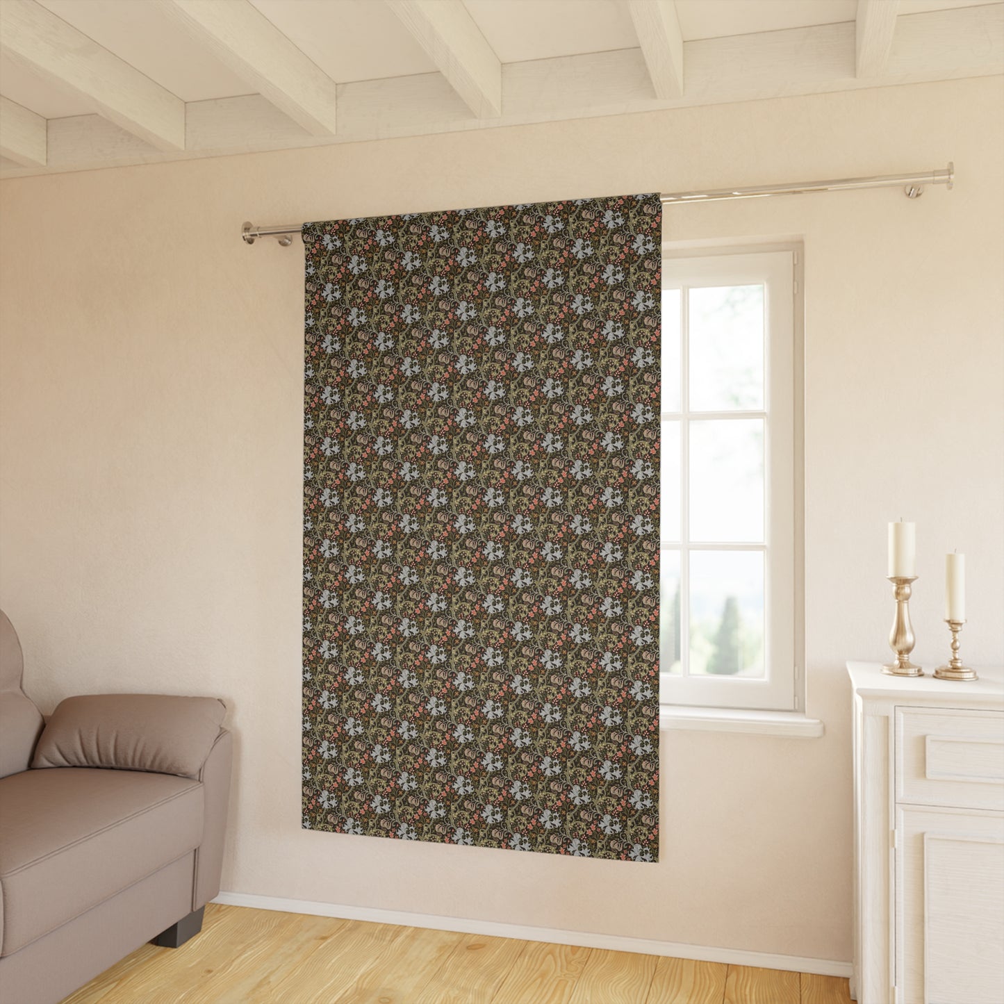 Floral patterned curtain hanging in a room with a sofa and window.