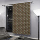 Floral patterned curtain hanging in a modern room with a black door and gray floor.