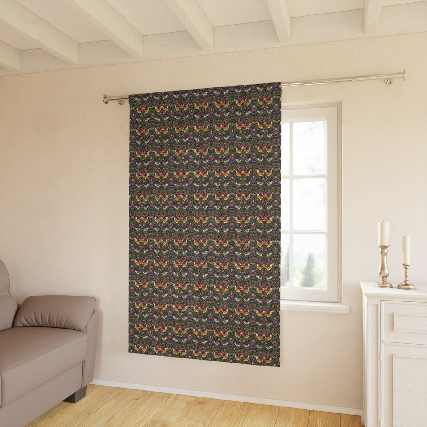 Patterned curtain hanging in a room with a sofa and window.