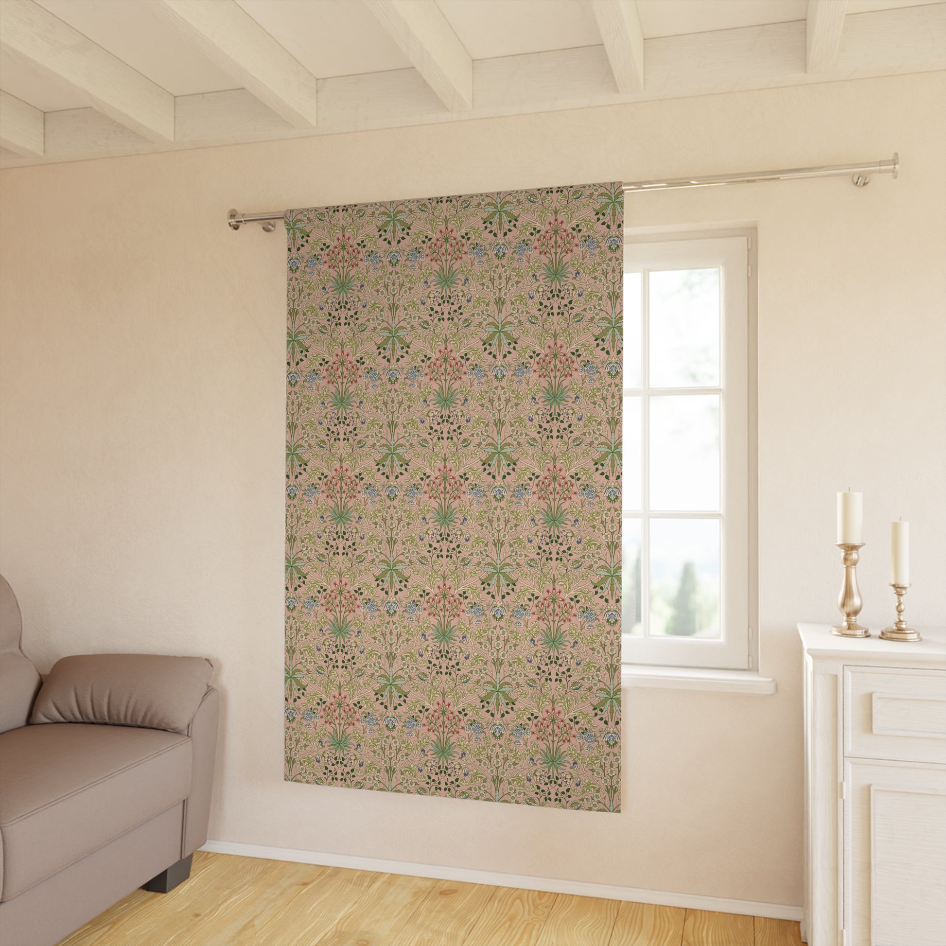 Decorative curtain with floral pattern in a room with a sofa and window.