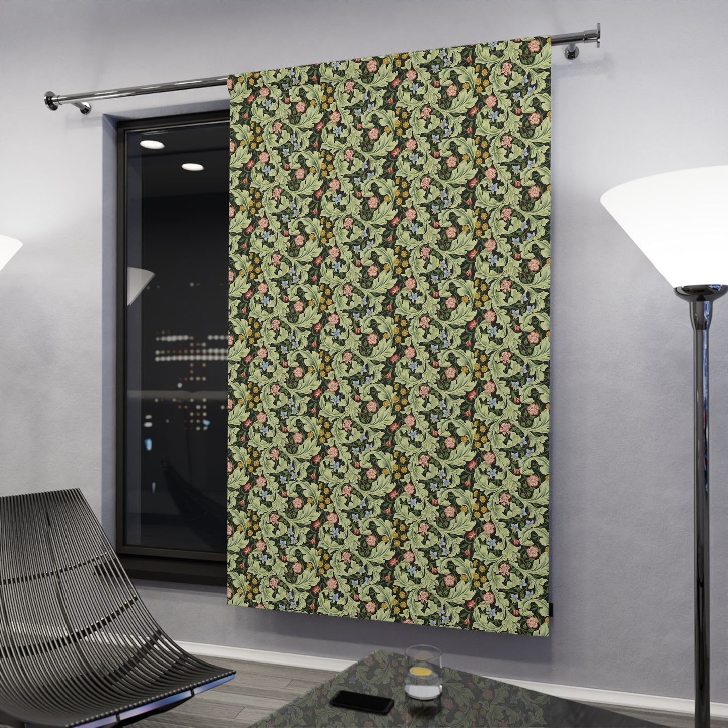 Floral patterned curtain hanging on a rod in a room with modern decor.