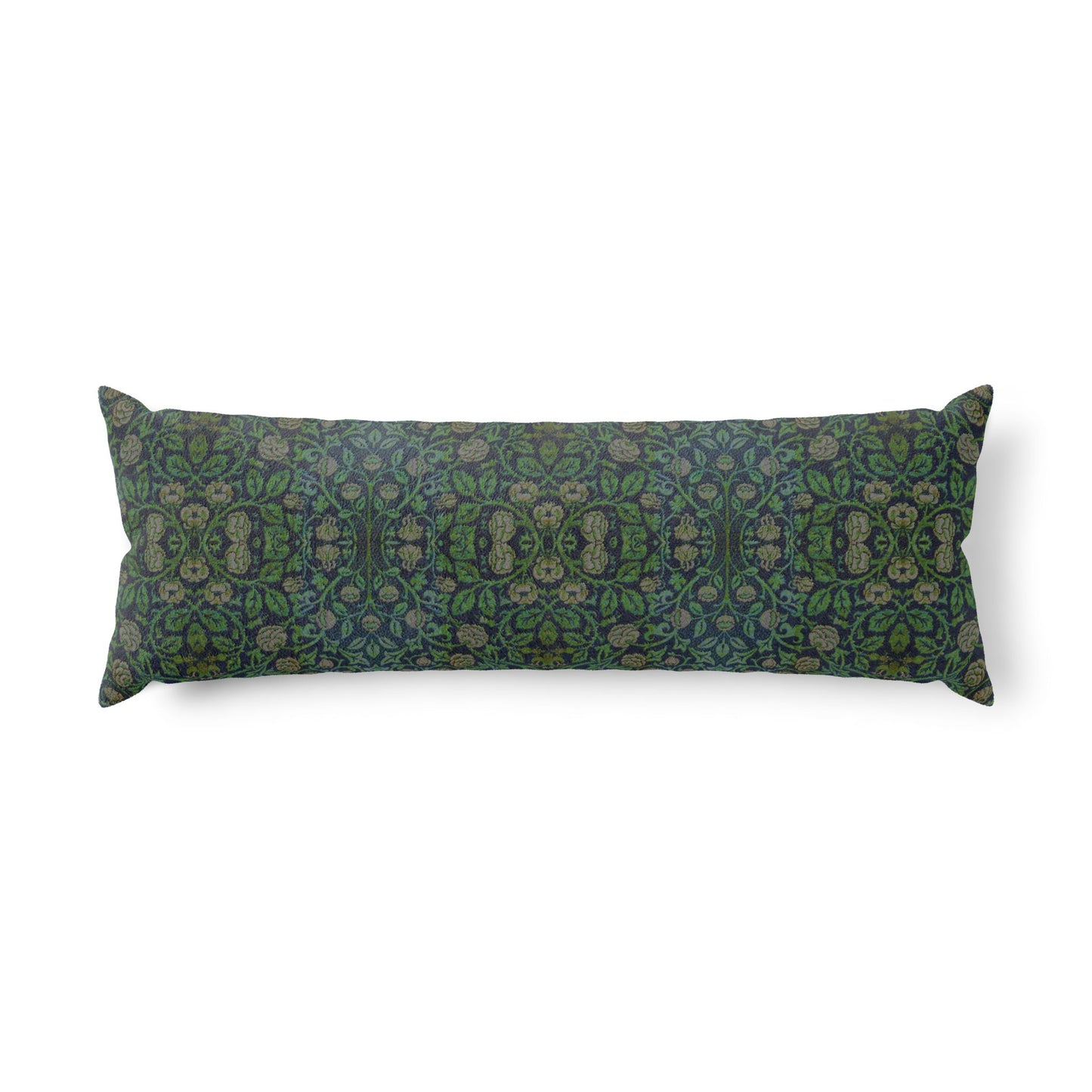 A long rectangular lumbar pillow with an intricate William Morris & Co green and brown paisley pattern rests on a bed with cream bedding and white pillows in a minimalist, warm-toned bedroom.