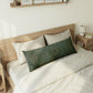 Decorative floral pillow on a bed in a bedroom setting