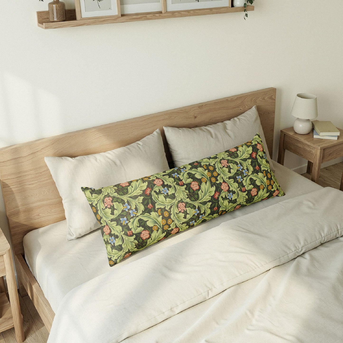 Floral patterned pillow on a bed with wooden headboard and nightstand.