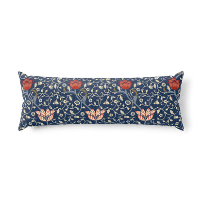 A long rectangular lumbar pillow featuring a navy blue background with a dense cream floral and vine pattern, accented by coral-red flowers and peach leaves.