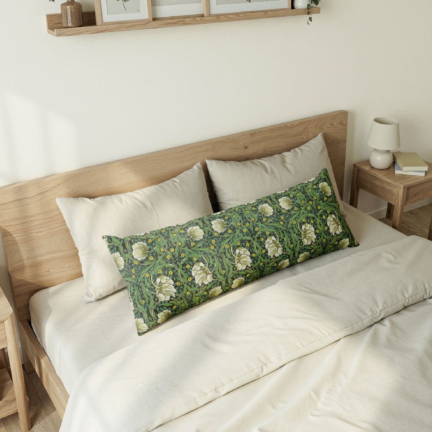 Bedroom with a wooden bed frame and decorative pillows, including a green floral pillow.