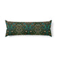 A long rectangular lumbar pillow featuring a dense floral and botanical pattern in dark green, teal, orange, and cream on a solid white background.