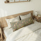Bedroom with wooden headboard and floral-patterned pillow