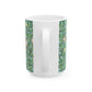 A ceramic mug with a blue background featuring a floral pattern of birds and pomegranates.
